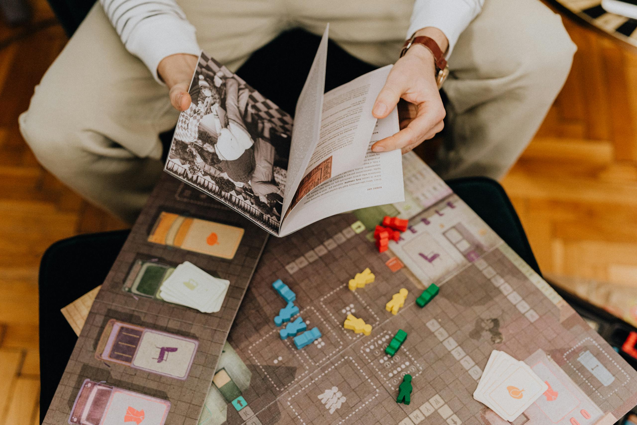 Adult and child reading chess instructions while setting up a chess game.