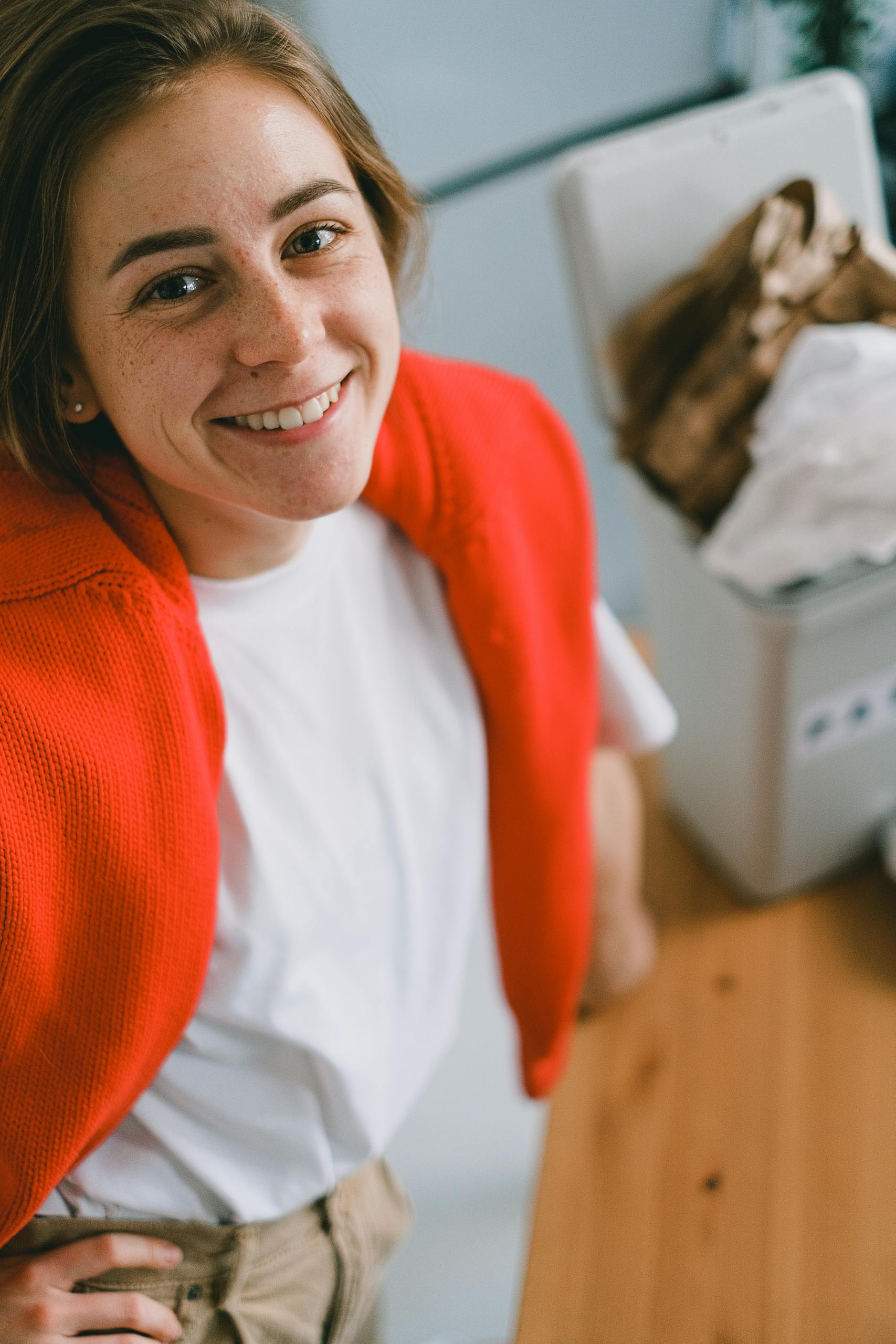 Close-up of a mature woman with short hair using a smartphone indoors, selective focus.
